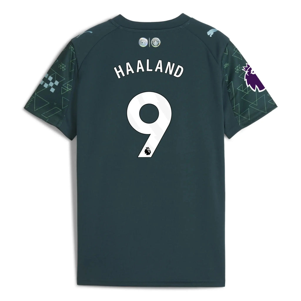 A dark teal Manchester City home jersey shown from the back, featuring 'HAALAND' and the number '9' in white, with patterned sleeves.