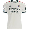 A white Real Madrid soccer jersey by adidas, featuring the club crest on the chest, the adidas logo, Emirates Fly Better sponsor text, and dark green and red shoulder accents.